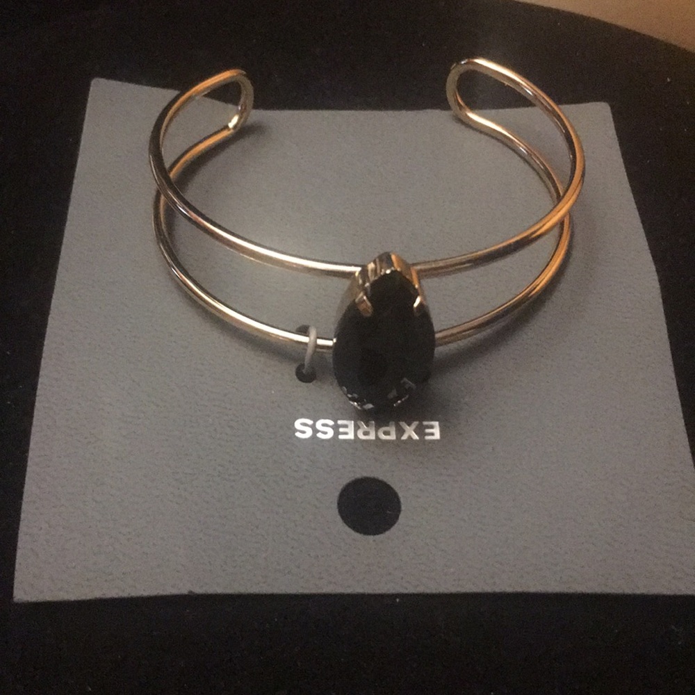 Express gold cuff bracelet with dark blue stone